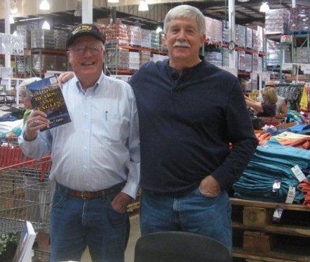 Retired game warden Gil Berg at a Costco book signing with author Steven T. Callan