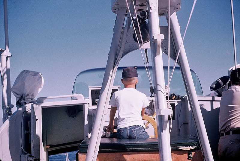 Author Steven T. Callan at the helm of the Fish and Game patrol boat Marlin, 1959.