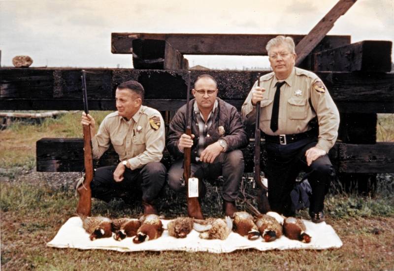 Pictured, left to right, are Warden Wally Callan, U.S. Fish and Wildlife Agent Bob Norris, and Warden Harold Erwick, circa 1965, with evidence seized during a pheasant case. Photo courtesy of Steven T. Callan.