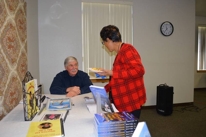 Author Steven T. Callan visits with a member of Redding Writers Forum during his visit to discuss his book The Game Warden's Son.