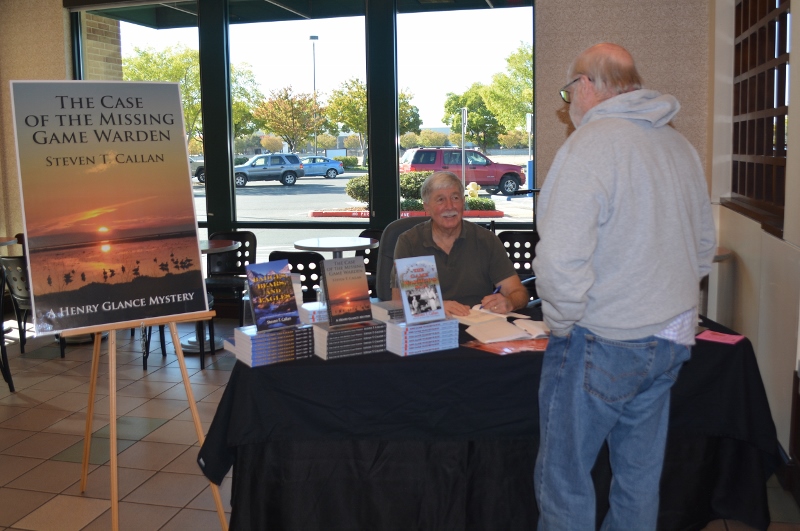 Author Steven T. Callan visits with a friend at the author's book signing at the Chico Barnes and Noble