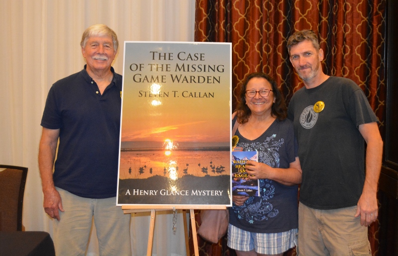 Author Steven T. Callan poses with friends at book signing for his award-winning novel ,The Case of the Missing Game Warden